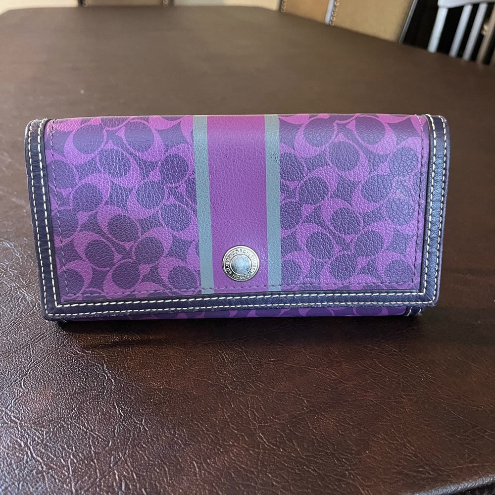 Coach purple leather wallet in signature print. Snap closure